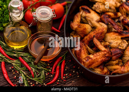 Baked chickens wings covered in honey, vegetables Stock Photo