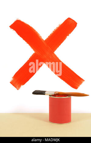 Red cross or letter X painted on a white wall with paint can and paintbrush. Stock Photo