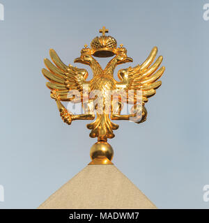 Golden Coat of arms of the Russian Federation close-up on the background of the sky Stock Photo