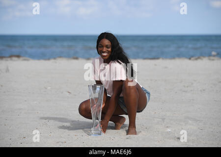 Key Biscayne, FL, USA. 31st Mar, 2018. Sloane Stephens poses with the championship trophy on Crandon Beach after defeating Jelena Ostapenko during the Womens Final the Miami Open at Crandon Park Tennis Center on March 31, 2018 in Key Biscayne, Florida. Credit: Mpi04/Media Punch/Alamy Live News Stock Photo