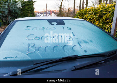North Wales, UK Weather:  With an already washed out Easter Bank Holiday from rain many people awake to a frosty start to Easter Sunday with snow on the way. A motorist discovers frost on a car windscreen with snow arriving through the night in Flintshire, North Wales Stock Photo