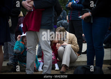 Washington, DC, USA. 1st April, 2018. Valerie Boyd (right) is joined by her daughters Theresa, 8, (center) and Cadence, 9, (left) as they and thousands of people take part in the 40th Annual Easter Sunrise service on the steps of the Lincoln Memorial. This event began in 1979 with a small group of people and has grown to be one of the largest Easter sunrise prayer services in the United States, which draws people from the Washington, DC area as well as from all over the world. Rod Lamkey Jr./Alamy Live News Stock Photo