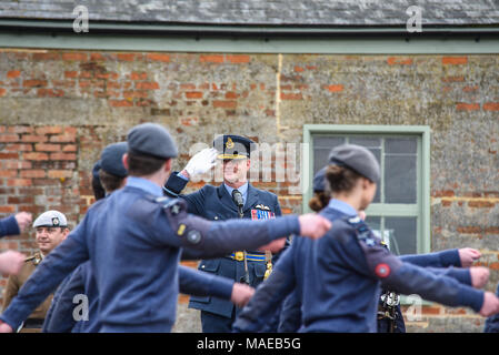 The Royal Air Force was formed during the Great War on 1st April 1918 from its forebears the Royal Flying Corps and the Royal Naval Air Service. To mark the 100th anniversary a celebration event was held on the unique World War One Aerodrome at Stow Maries. Air Commodore Jez Attridge saluting marching air cadets Stock Photo