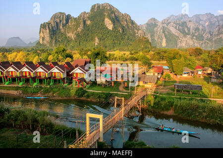 Row of tourist bungalows along Nam Song River in Vang Vieng, Vientiane Province, Laos. Vang Vieng is a popular destination for adventure tourism in a  Stock Photo