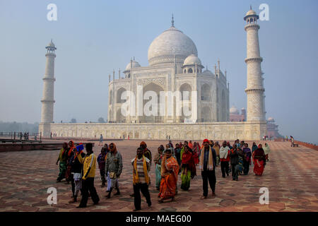 Group of people walking at Taj Mahal complex in Agra, Uttar Pradesh, India. Taj Mahal was designated as a UNESCO World Heritage Site in 1983. Stock Photo