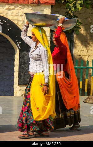 Local women carrying metal buckets on their heads in Agra, Uttar Pradesh, India. Agra is one of the most populous cities in Uttar Pradesh Stock Photo