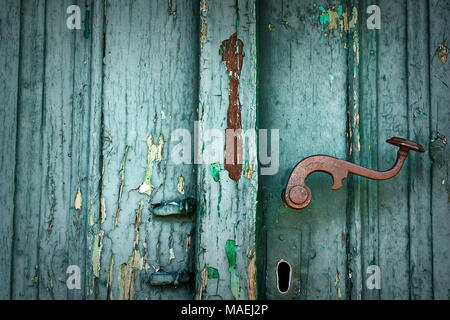 weathered wood texture on old door with rusty beautiful doorknob Stock Photo