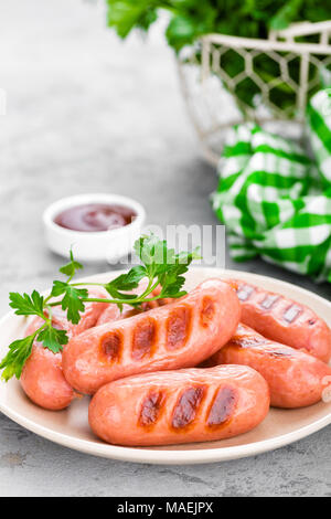 Grilled sausages on plate. BBQ sausages. Stock Photo