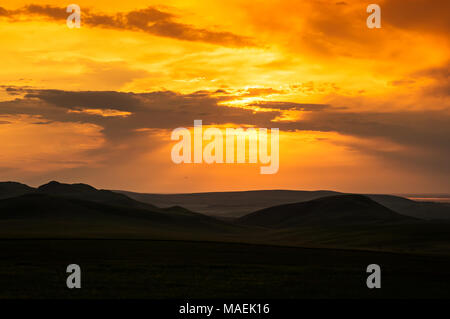Hills and bright sky during sundown. Stock Photo