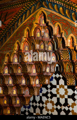 Morocco, Fes, Fes el Bali, Medina, historic house interior, zellij and carved wooden fire surround Stock Photo