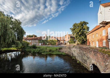 Picturesque cottages and millpond under a blue summer sky, Burnham Overy Staithe, Norfolk, UK. Stock Photo