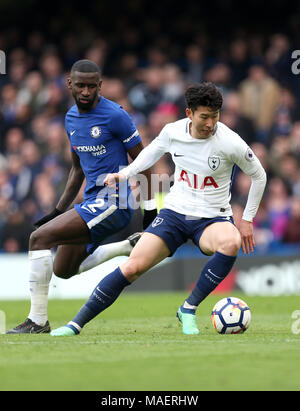 Chelsea's Antonio Rudiger (left) and Tottenham Hotspur's Son Heung-Min battle for the ball during the Premier League match at Stamford Bridge, London Stock Photo