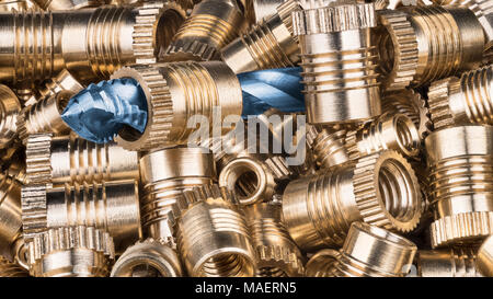 Bronze thread inserts and spiral flute tap. Pile of gold threaded ...