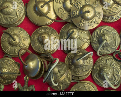 New brass ritual Tibetan Buddhist musical plates on a red background for sale. Stock Photo