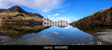 Looking towards the northern end of Buttermere with Melbreak perfectly reflected on a crisp spring morning Stock Photo