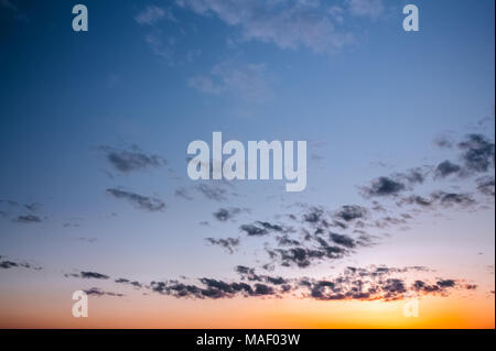 Sunset evening sky with sparse clouds background Stock Photo