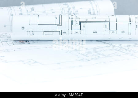 architectural project drawings and blueprints rolls on desk as construction background Stock Photo
