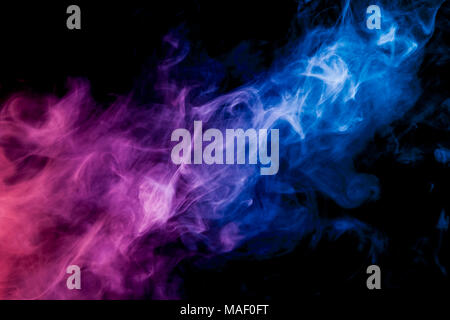 Dense multicolored smoke of   blue, and pink colors on a black isolated background. Background of smoke vape Stock Photo