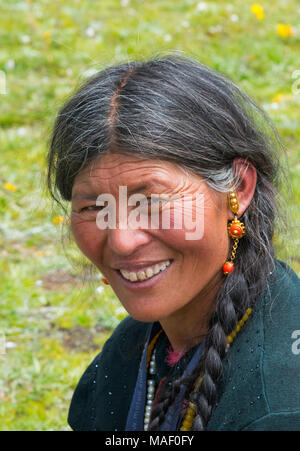 Tibetan woman in traditional clothing at Horse Race Festival, Litang, western Sichuan, China Stock Photo