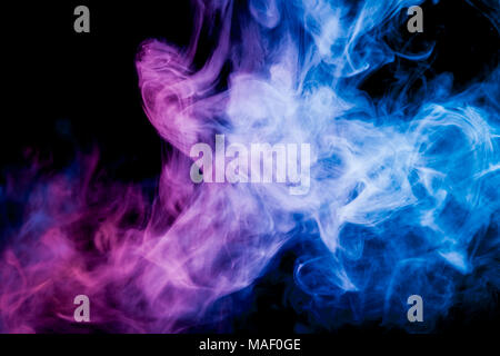 Dense multicolored smoke of   blue, and pink colors on a black isolated background. Background of smoke vape Stock Photo