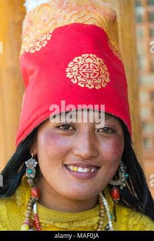 Tibetan woman in traditional clothing spinning prayer wheels,Palcho