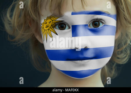 Portrait of a child with a painted Uruguayan flag Stock Photo