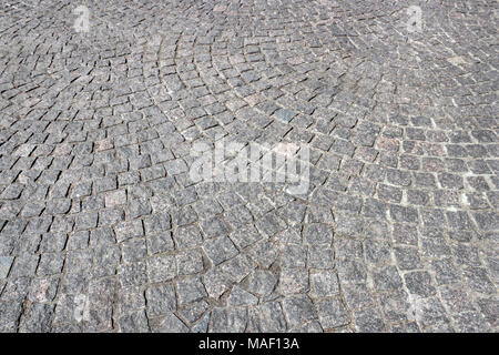 Cobbled pavement of gray granite close up as background Stock Photo