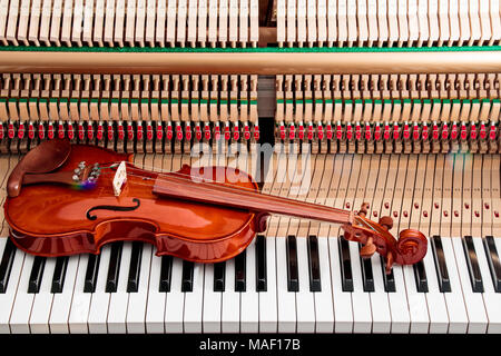 violin on black and white piano keys with inside to the piano background Stock Photo