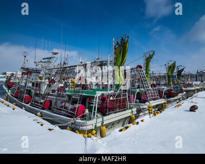 Hokkaido Winter - Squid fishing boats tied up in Hakodate Harbour, Hokkaido, Japan. Winter in Japan. Japanese Fishing Fleet. Stock Photo
