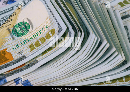 Dollars rolled closeup. American Dollars Cash Money. One Hundred Dollar Banknotes. Lots of dollar bank notes on the table Stock Photo