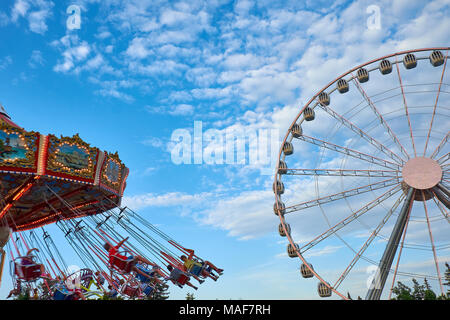 Ferris wheel and carousel in motion blur, Oktoberfest in Munich Stock Photo