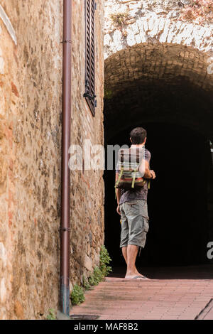 Solo traveler facing dark portal Stock Photo
