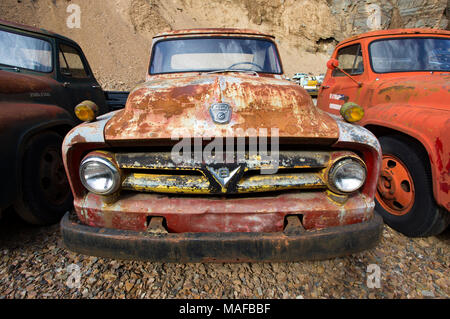 The front of an old, red 1953 Ford F-500 farm truck, in a stone quarry, east of Clark Fork Idaho. Stock Photo