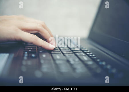 Woman's hand typing with laptop. focus on his finger. Stock Photo