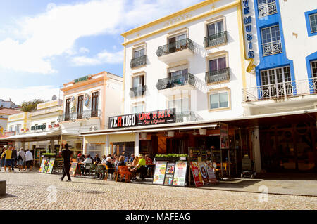 Tourists eating and drinking in restaurants in the old town of Albufeira, Portugal Stock Photo