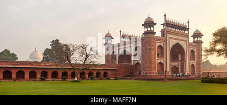 The four storey main gateway of the Taj Mahal is 100 feet high and is built in red sandstone. The Arabic calligraphy is from the Holy Quran. Stock Photo