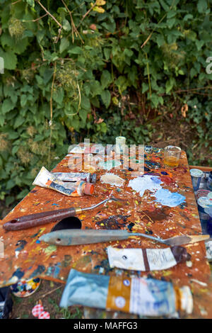 An artists oil paint palette in use out on location. Stock Photo