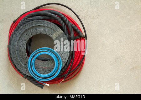 Heating floor system wires and cables. Renovation and construction concept. Comfort house. Stock Photo
