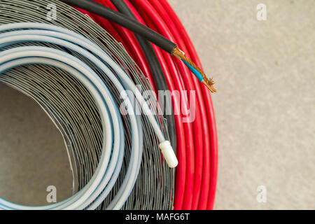 Heating floor system wires and cables. Renovation and construction concept. Comfort house. Stock Photo
