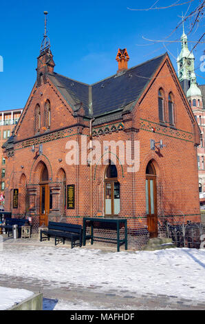 A small and elegant building, in the Speicherstadt, historic port area of Hamburg, probably originally connected with adjacent bridge, now a café bar. Stock Photo