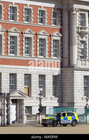 Armed officer outside the Old Admirality Building in London Stock Photo