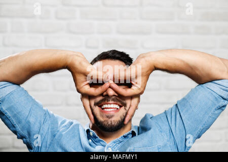 Portrait of happy Italian man smiling. Guy looking at camera and doing funny hand gestures with hands and fingers Stock Photo