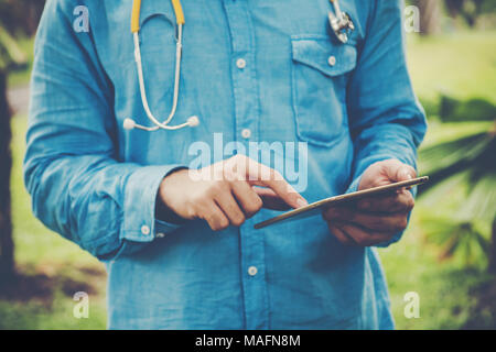 Young student using tablet PC outside on a park . Stock Photo