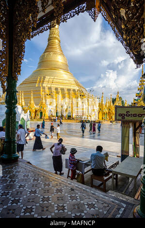 The Shwedagon Pagoda officially named Shwedagon Zedi Daw and also known as the Great Dagon Pagoda, is a gilded stupa located in Yangon Myanmar Stock Photo