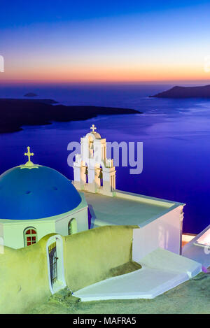 Santorini, Greece. Firostefani twilight with old greek church and caldera at Aegean Sea. Stock Photo