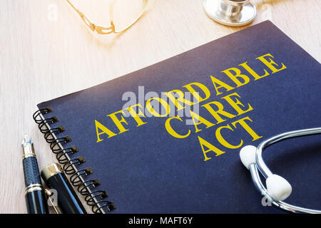 Affordable Care Act ACA and stethoscope on a table. Stock Photo