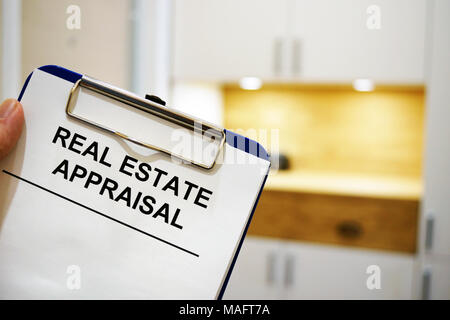 Man holding clipboard with Real estate appraisal. Stock Photo