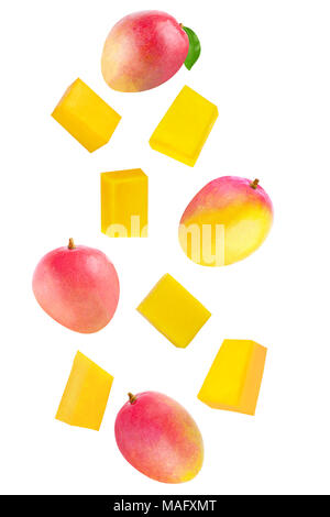 Isolated flying fruits. Whole and cubes falling mango fruit isolated on white background with clipping path as package design element and advertising. Stock Photo