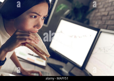 Breakfast in work place. Important news, information. Indoor, studio shot. Business people concept, work in office Stock Photo