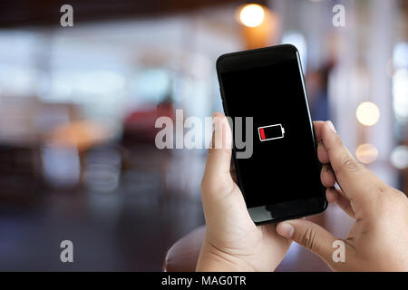 Close up man hands using smart phone battery low charged battery screen Stock Photo